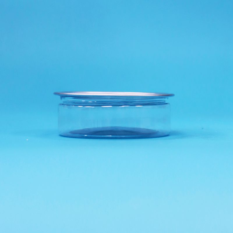 Okrągły plastikowy pojemnik PET z metalowym wieczkiem typu easy open do pakowania żywności, cukierków, ciasteczek i przekąsek